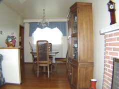 Cozy dining room off of living room also has hardwood flooring 