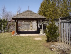Large fenced rear yard with covered gazebo. 