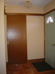 Front foyer has pocket door to the kitchen & ceramic flooring. 
