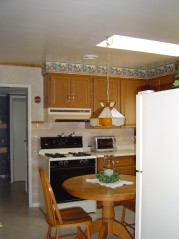 Kitchen has gas hookup for your stove, a sunny skylite and window that overlooks the yard and an attractive french door to the dining room 