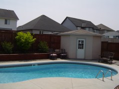 Custom corner shed for all your pool equipment. It has hydro too! 