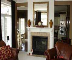 Family room shares double sided gas fireplace with kitchen